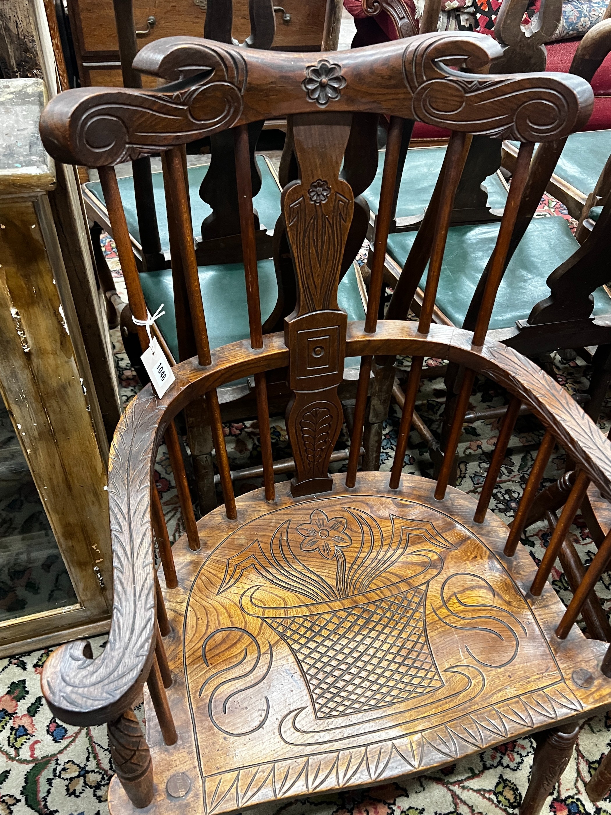 A pair of carved elm Windsor armchairs, width 69cm, depth 45cm, height 107cm